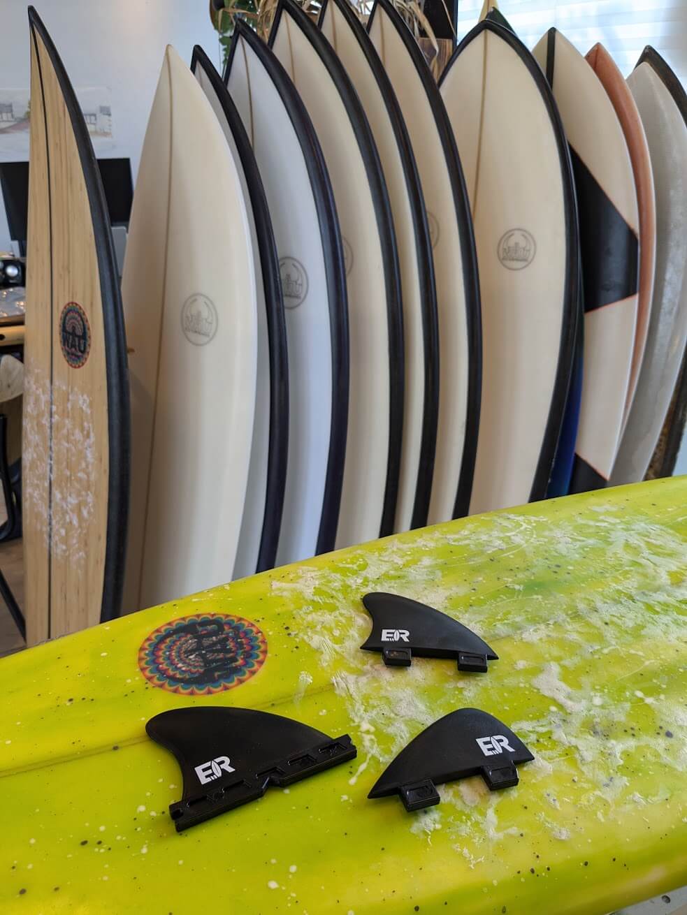Surfboards lined up with fins at the Eisbach in Munich